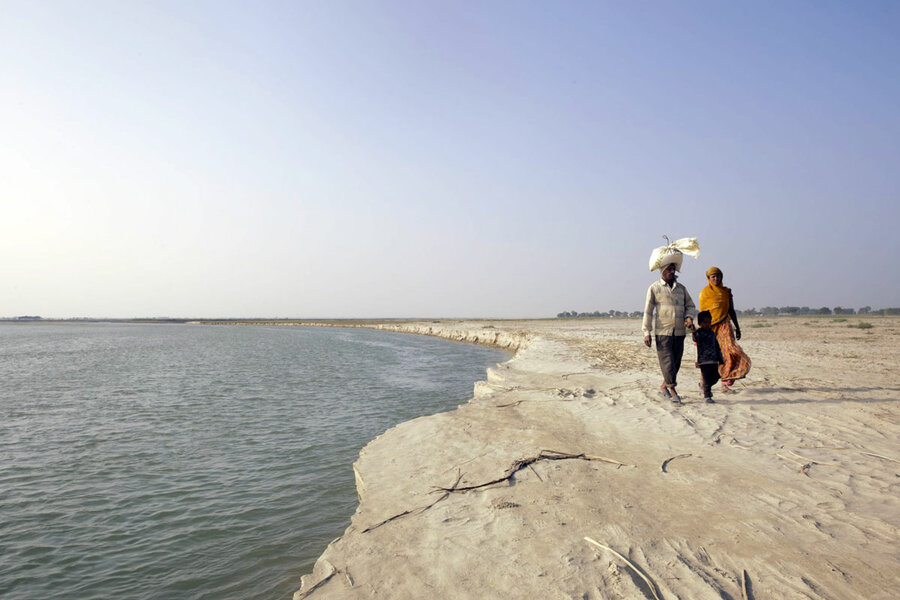 a family walking along the shore